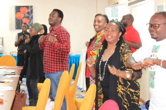 Staff dancing to a tune in a seminar